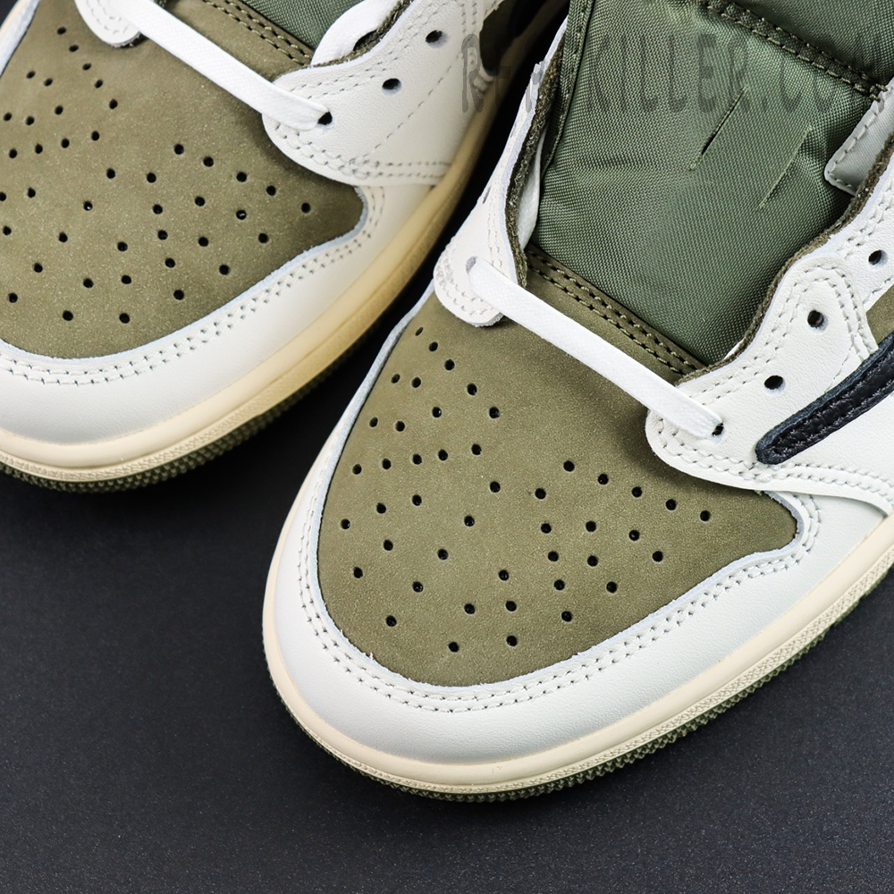Close-up of the toe box on the Travis Scott Air Jordan 1 Low Reverse Olive with green nubuck and white leather overlays.