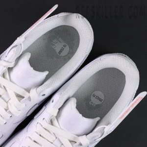Overhead view of Nike Air Force 1 ’07 “Triple White” showing grey mesh insoles with size stickers.