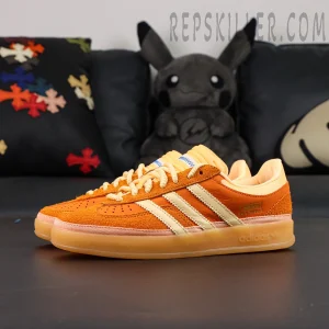 Lateral side angle of the Bad Bunny x Gazelle Indoor ‘Santurce’ highlighting orange upper with cream Three-Stripes.