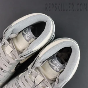 Close-up top view of Dior x Air Jordan 1 High showing padded collar and Dior Air tongue tag.