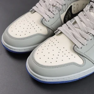 Close-up of Dior x Air Jordan 1 High perforated leather toe box with flat laces.