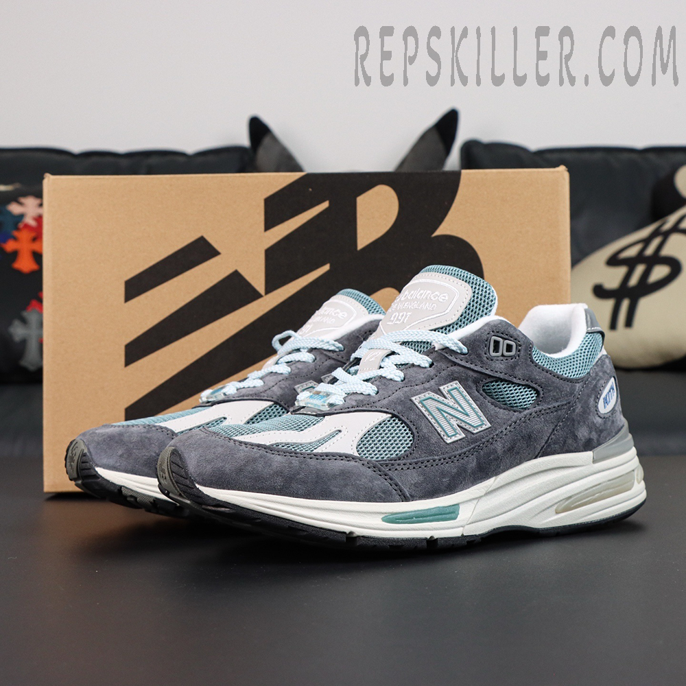 Kith x New Balance 991v2 ‘Osaka Pack’ display with brown New Balance box in background