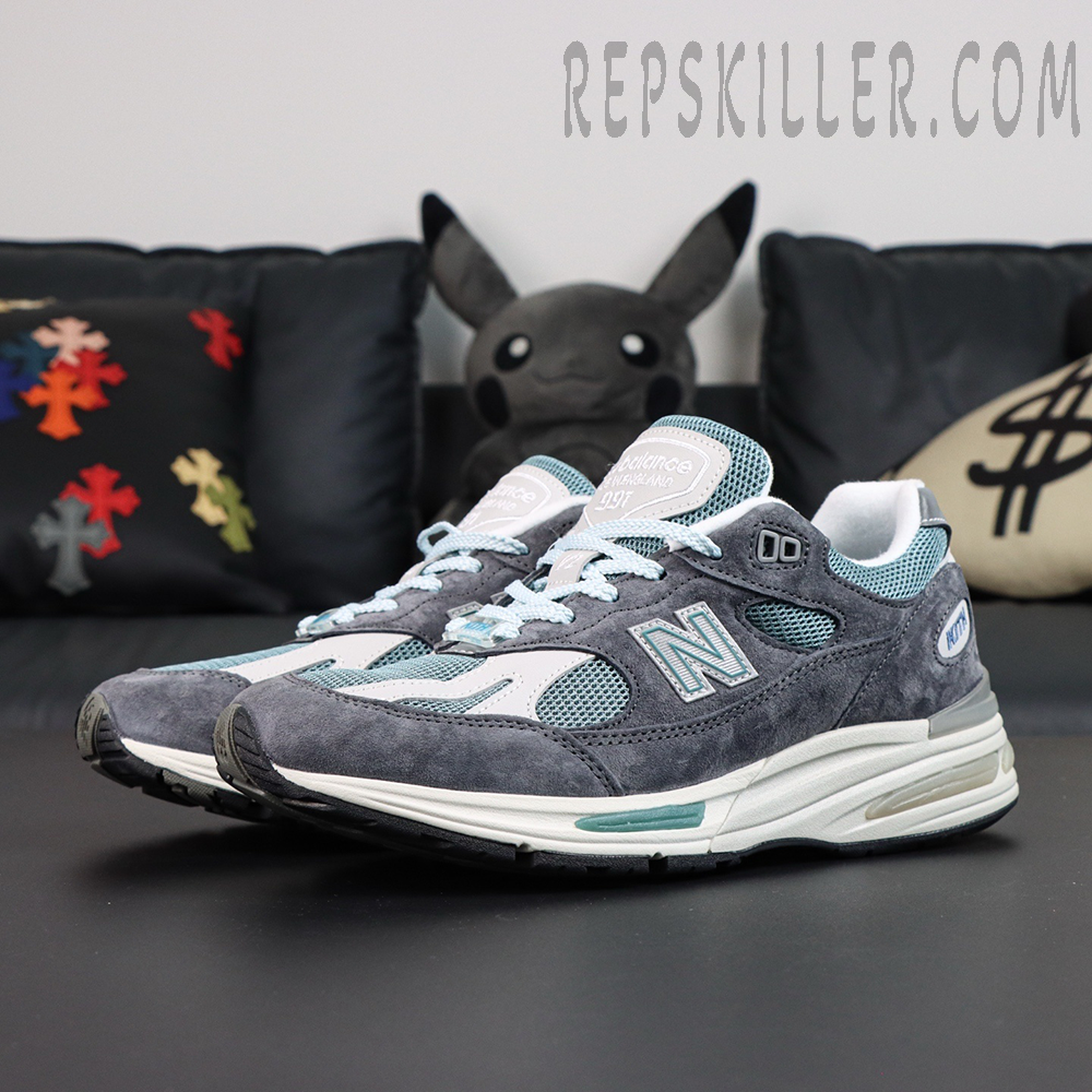 Kith x New Balance 991v2 Made in England ‘Osaka Pack’ side view showing grey suede overlays and teal mesh panels