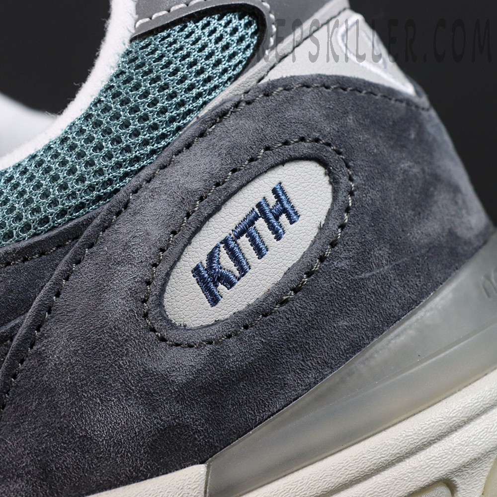 Macro shot of Kith x New Balance 991v2 ‘Osaka Pack’ suede heel area with navy embroidered KITH branding