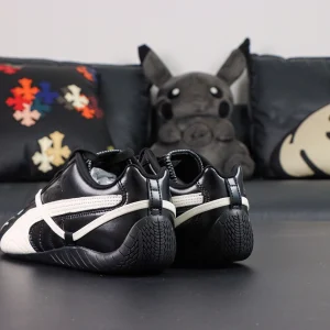 Rosé x Wmns Speedcat Premium ‘Black’ rear-angled view emphasizing sculpted black outsole tread and wrapped-around off-white secondary lace.