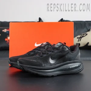 Nike Vomero 18 ‘Triple Black’ full side profile with original orange Nike box positioned behind the shoe