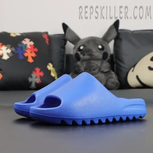 Yeezy Slides ‘Azure’ angled side view highlighting bold blue color and minimal design