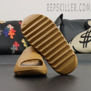 Yeezy Slides ‘Ochre’ outsole and toe front view on black background
