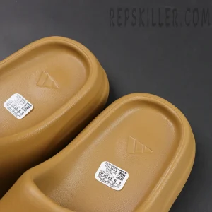 Top view of Yeezy Slides ‘Ochre’ footbed with Adidas logo and label