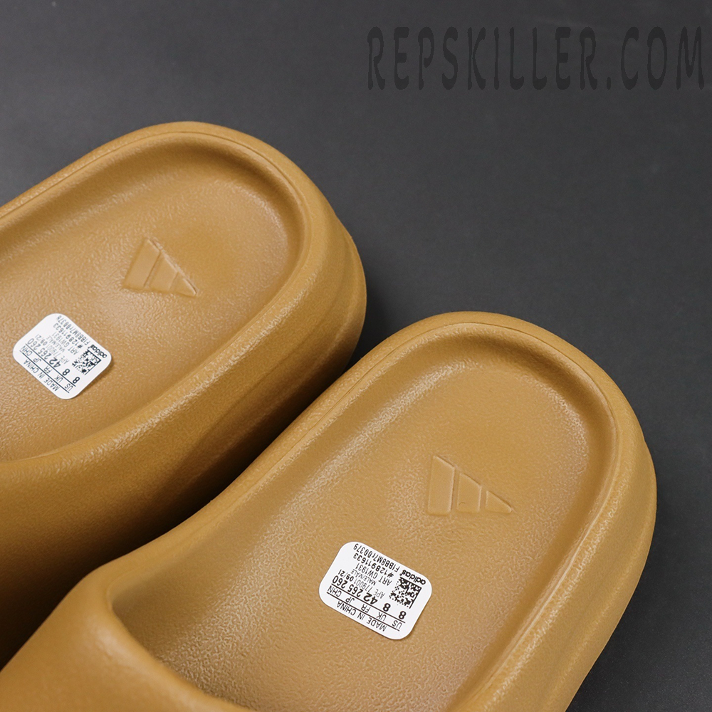 Top view of Yeezy Slides ‘Ochre’ footbed with Adidas logo and label