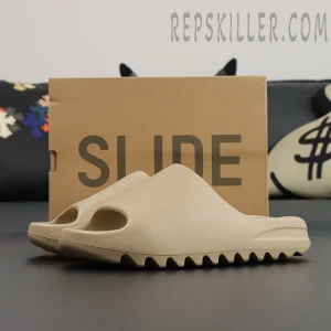 Yeezy Slides ‘Pure’ pair in front of slide box for branding shot
