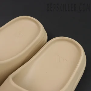 Yeezy Slides ‘Pure’ footbed close-up showing adidas embossed logo