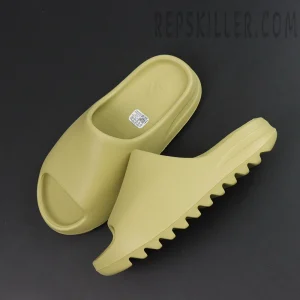 Pair of Yeezy Slides ‘Resin’ 2022 with serrated outsole for traction.