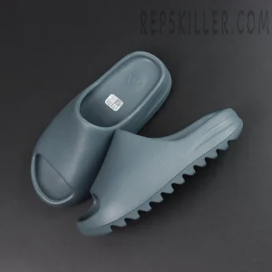 Top-down flat lay of the Yeezy Slides ‘Slate Marine’ showing the footbed and outsole.