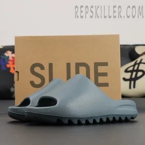 Side profile of the Yeezy Slides ‘Slate Marine’ showing minimal design and clean ridges.