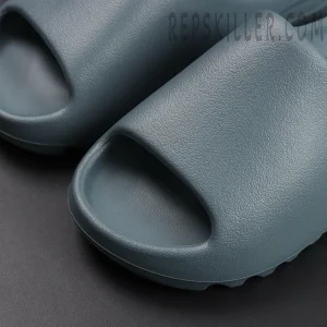 Detailed toe box view of the Yeezy Slides ‘Slate Marine’ in slate blue finish.