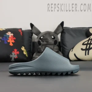 Side profile of the Yeezy Slides ‘Slate Marine’ showing minimal design and clean ridges.