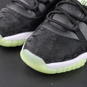 Air Jordan 11 Retro GS ‘Inner Beast’ — Close-up of the textured black suede mudguard and semi-translucent green toe cap.