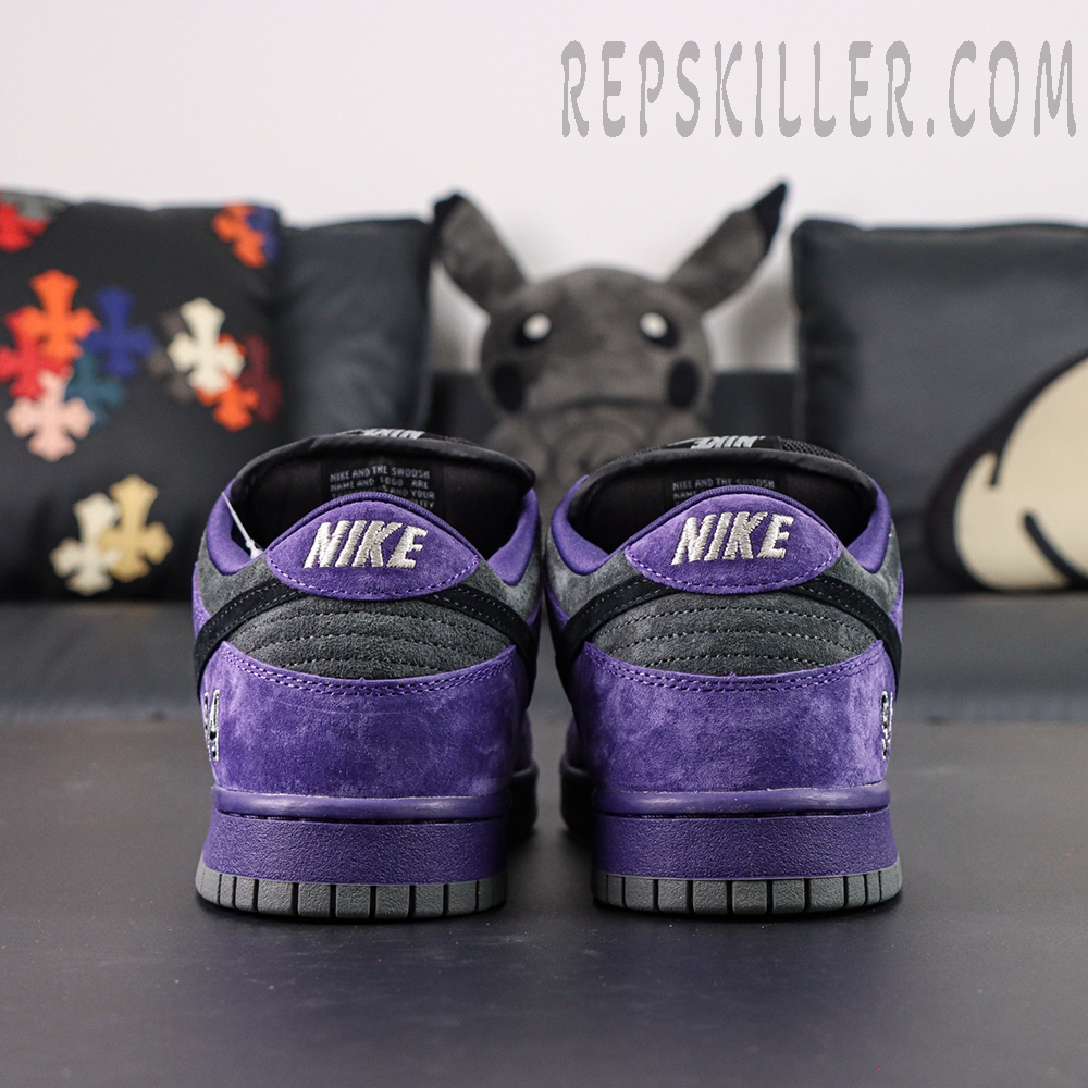 Nike Supreme x Dunk Low SB “Ink” rear heel view with bold NIKE embroidery in white over purple suede.
