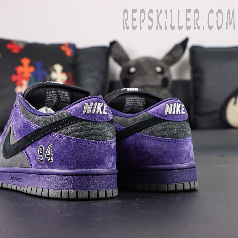 Nike Supreme x Dunk Low SB “Ink” rear angle showing embroidered 94 and layered color blocking of suede panels.