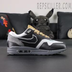 Side profile of Nike Air Max 1 “Low Poly - Big Head Mode” showing visible Air cushioning and premium layered leather texture.