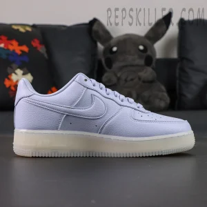 Side profile of NOCTA x Nike Air Force 1 “Palest Purple” showing full tumbled leather upper in light lavender tone.