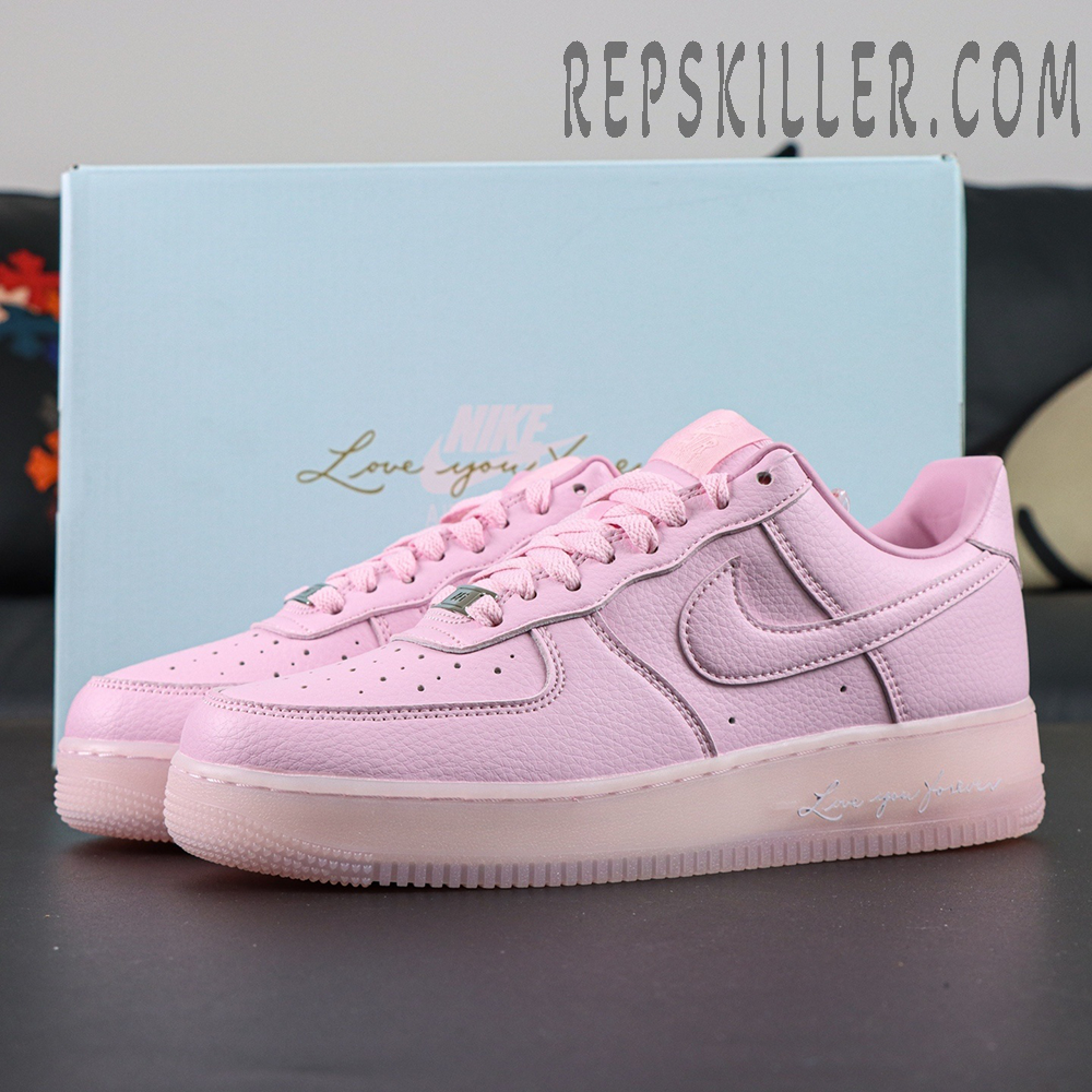 NOCTA x Air Force 1 “Pink Foam” with blue box background showing clean pastel pink tone.