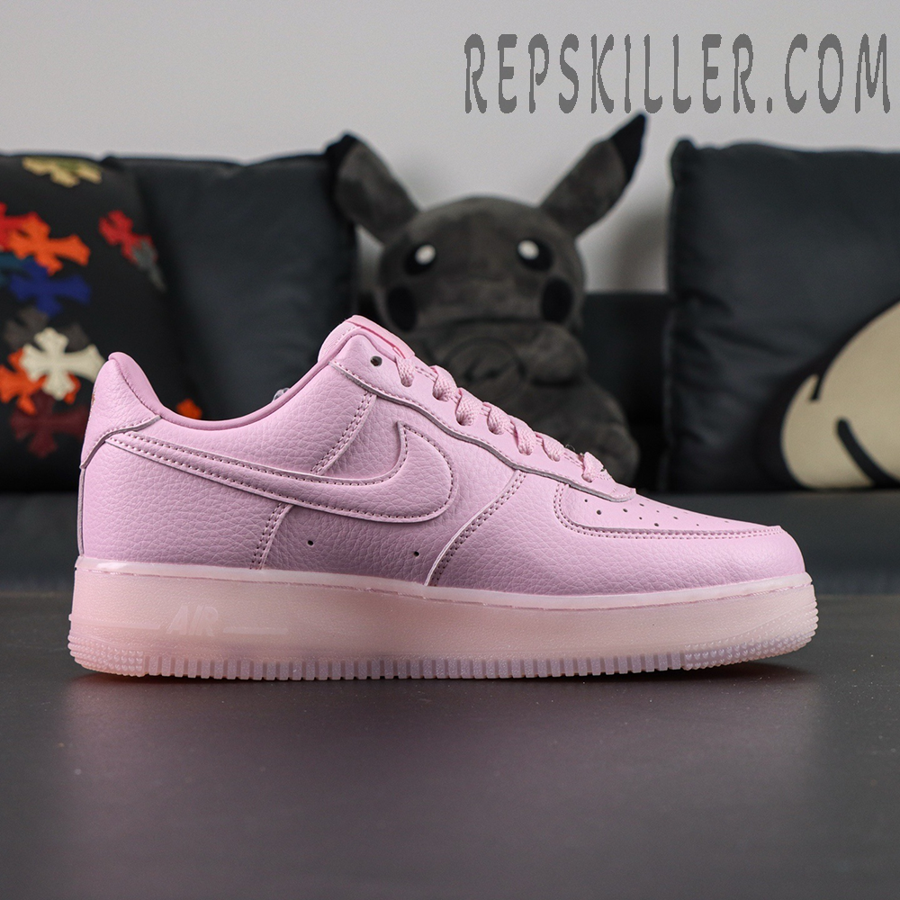 Side profile of NOCTA x Nike Air Force 1 “Pink Foam” highlighting full pink tumbled leather upper.
