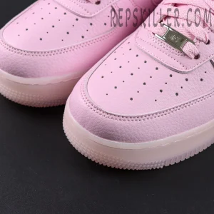 Close-up of NOCTA x Air Force 1 “Pink Foam” toe box showing perforations and premium leather texture.