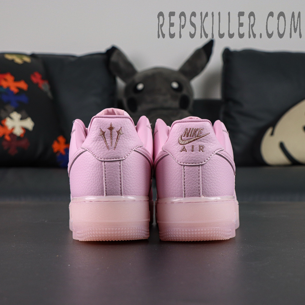 Rear view of NOCTA x Nike Air Force 1 “Pink Foam” showing embroidered Nike Air and NOCTA trident logos.