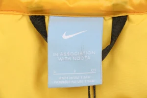 Nike x Drake NOCTA Stand Collar Down Jacket Yellow Brand label