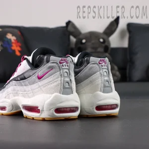 Angled heel view of Nike SB x Air Max 95 “Cactus Flower” highlighting pink Swoosh embroidery on grey suede panels.