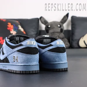 Rear view of Supreme x Nike SB Dunk Low “Ocean Fog,” focusing on the silver Nike logo on the heel tab.