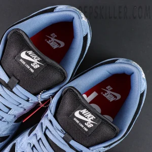 Top close-up of the tongue and insole of Supreme x Nike SB Dunk Low “Ocean Fog,” featuring red Supreme logo insoles.