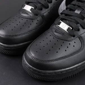 Close-up of Supreme x Nike Air Force 1 Low SP ‘Box Logo - Black White’ toe area showing perforated leather and metal lace tag