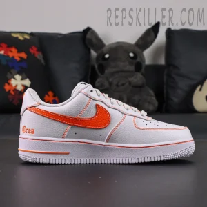 Side profile of Vlone x NikeLab Air Force 1 ‘White’ showing orange Nike swoosh and contrast stitching