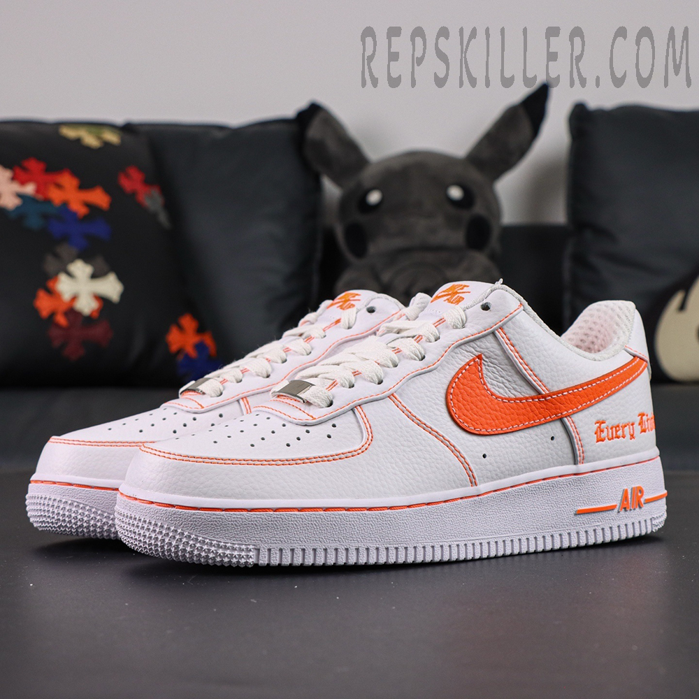Angled view of Vlone x NikeLab Air Force 1 ‘White’ displaying orange stitched details and branding