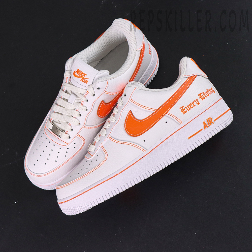 Overhead display of Vlone x NikeLab Air Force 1 ‘White’ with bright orange swoosh accents