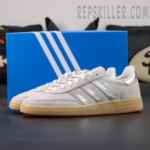 Adidas Handball Spezial Grey Silver Gum side profile featuring grey suede upper and silver stripes with blue adidas box behind