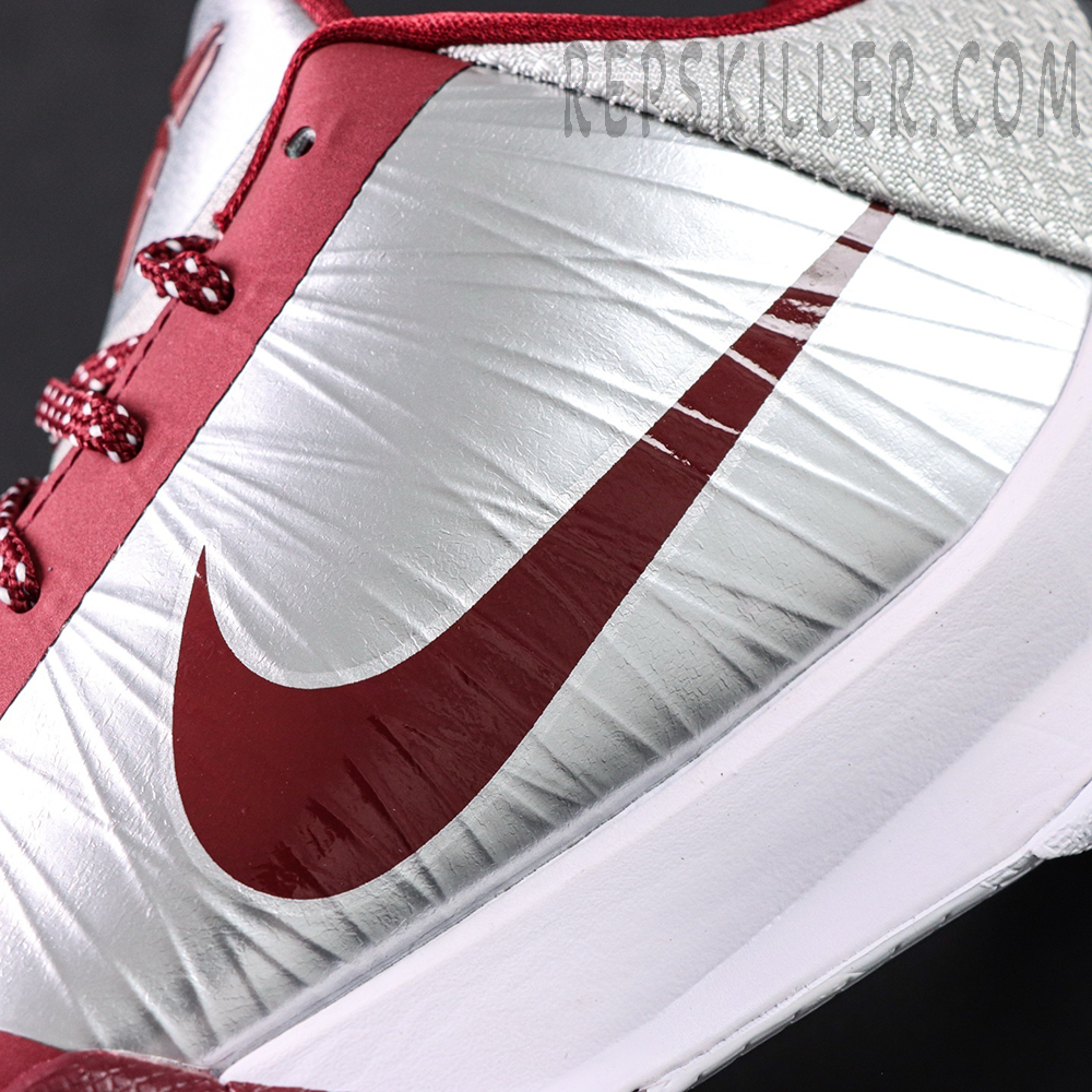 Close-up of red Nike Swoosh on silver upper of Kobe 5 Protro ‘Lower Merion Aces’.
