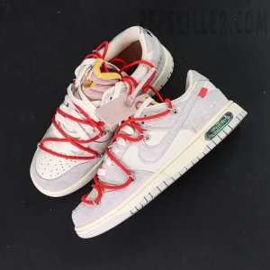 Top-down angle of Off-White x Nike Dunk Low Lot 33 of 50 displaying red lace overlay and pink zip tie.