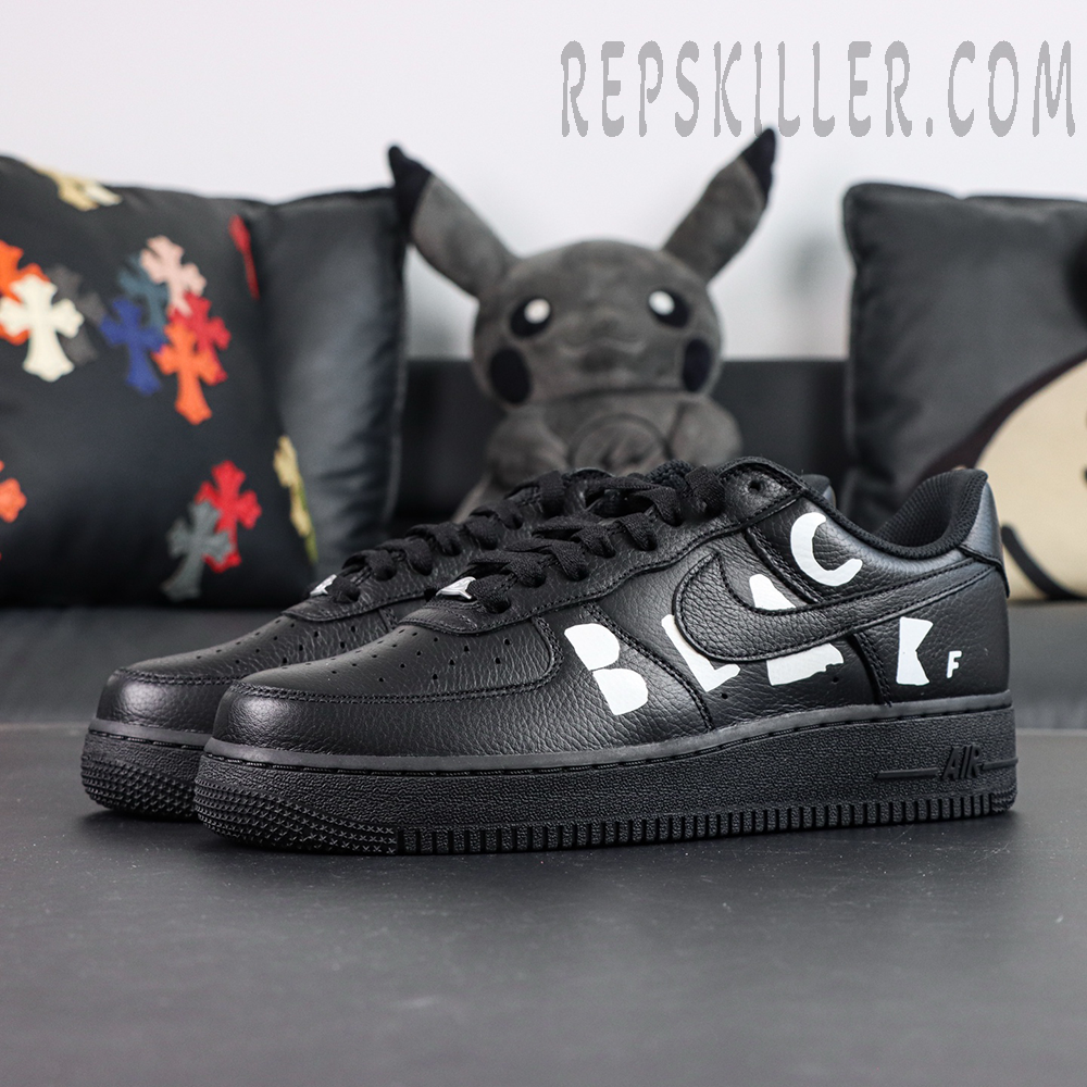 BLACK Comme des Garçons x Nike Air Force 1 Low black collaboration sneakers, front side angle with white “BLACK” lettering detail