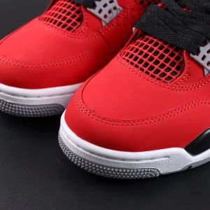 Close-up view of the Jordan 4 Retro Toro Bravo red nubuck toe box with visible stitching and textured outsole edge