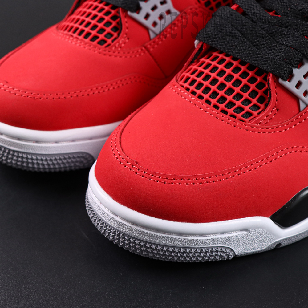Close-up view of the Jordan 4 Retro Toro Bravo red nubuck toe box with visible stitching and textured outsole edge