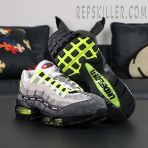 Undefeated x Nike Air Max 95 “NYC Neon” sneakers, outsole-up view with neon green traction and UNDEFEATED branding