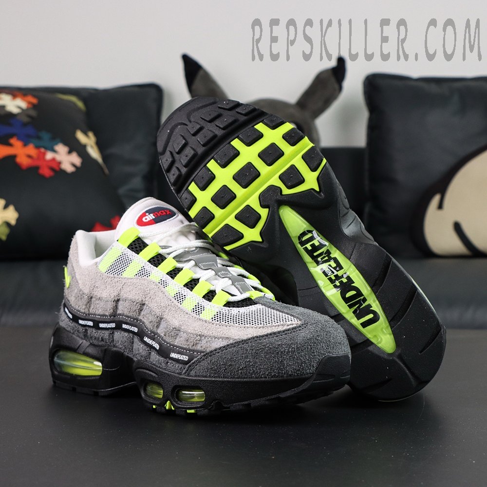 Undefeated x Nike Air Max 95 “NYC Neon” sneakers, outsole-up view with neon green traction and UNDEFEATED branding