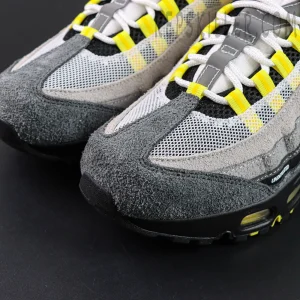 Undefeated x Nike Air Max 95 “Yellow” sneakers, toe box close-up with suede overlay and mesh upper detail