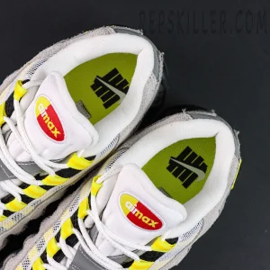 Undefeated x Nike Air Max 95 “Yellow” sneakers, tongue and inner lining close-up with Air Max logo and neon insole